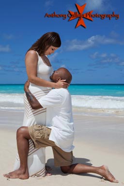 Engagement couple caressing and looking into each others eyes Waimanalo Beach Oahu Hawaii