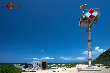 In 1919, the Bureau of Lighthouses decided to place an unmanned acetylene light on Kaena Point. A site was selected, building materials were hauled in, & a concrete pyramidal tower was erected at a cost of $2,479.84. Due to its remoteness, the light frequently fell victim to vandalism. Between 1980 & 1985, the light was extinguished eleven times, as senseless people shot at the lens or stole the beacon's batteries. In 1990, the concrete tower literally fell victim to erosion & was replaced by a light atop a metal pole.