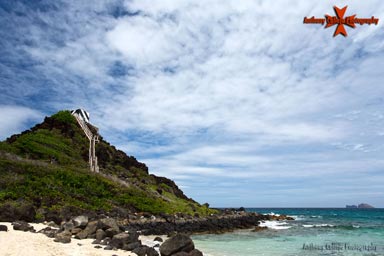 Kaneohe Bay on the windward or eastern side of Oahu is the largest sheltered body of water in the Hawaiian Islands. The 4.6-mile-wide mouth of the bay extends from Pyramid Rock on the Mokapu Peninsula at the southeastern side to Kualoa Point on the northwest side. Before exposure to the Western world in 1778, the Kaneohe area was the most populated area on Oahu. Part of the Mokapu Peninsula was first set aside for military purposes in 1918, when President Woodrow Wilson reserved 322 acres for the U.S. Army. The U.S. Navy purchased the western side of the peninsula in 1939, & construction soon began on Naval Air Station Kaneohe. Dredging of the bay started in 1939, & in 1941 Pyramid Rock Light was established atop the natural feature on the northwestern point of the Mokapu Peninsula.